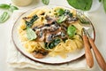Creamy Alfredo pasta. Italian pasta fettuccini with mushrooms, chicken meat, spinach, basil and cream sauce on white stone Royalty Free Stock Photo