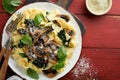 Creamy Alfredo pasta. Italian pasta fettuccini with mushrooms, chicken meat, spinach, basil and cream sauce on red old rustic Royalty Free Stock Photo