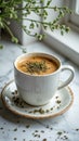 Creamy beverage in white cup with herbal topping and saucer on marble surface Royalty Free Stock Photo