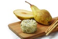 creamy blue stilton cheese, pears and cracker sticks on a cutting board, corner background fades to white, copy space