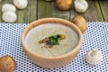 Creamy Champignon Soup in Wooden Bowl with SautÃÂ©ed Champignon M