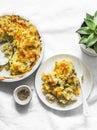 Creamy chicken breast, cauliflower, leek pie with crispy potato cheese topping on light background, top view Royalty Free Stock Photo