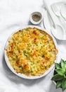 Creamy chicken, cauliflower, leek pie with crispy potato cheese topping on light background, top view. Comfort food Royalty Free Stock Photo