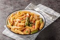 Creamy chipotle chicken penne pasta with asparagus, peppers, green peas, onion and garlic close-up in a bowl. horizontal Royalty Free Stock Photo