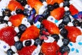 Creamy dessert with fresh strawberries and blueberries