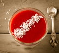 Creamy dessert with strawberry sauce and coconut flakes in glasses Royalty Free Stock Photo