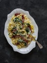 Creamy fettuccine pasta with dried tomatoes and spinach on a dark background, top view Royalty Free Stock Photo