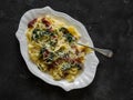 Creamy fettuccine pasta with dried tomatoes and spinach on a dark background, top view Royalty Free Stock Photo