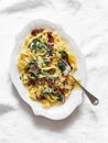 Creamy fettuccine pasta with dried tomatoes and spinach on a light background, top view Royalty Free Stock Photo