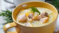 Creamy fish soup with salmon, potatoes, onions , carrots, dill and celery