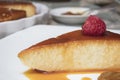 Creamy Flan dessert served with raspberries and dulce de leche