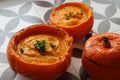 Creamy pumpkin soup and homemade bread on grey tiled table. Soup in a squash top view photo. Thanksgiving menu ideas.ÃÂ ÃÂ  Royalty Free Stock Photo