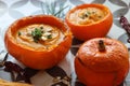 Creamy pumpkin soup and homemade bread on grey tiled table. Soup in a squash top view photo. Thanksgiving menu ideas.ÃÂ ÃÂ  Royalty Free Stock Photo