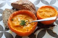 Creamy pumpkin soup and homemade bread on grey tiled table. Soup in a squash top view photo. Thanksgiving menu ideas.ÃÂ ÃÂ  Royalty Free Stock Photo