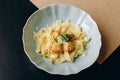 Creamy pasta with pieces of salmon and grated parmesan