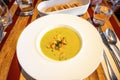Creamy pea soup with sliced fried bread on restaurant table