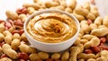 Creamy peanut butter in a white bowl surrounded by raw peanuts on a light background Royalty Free Stock Photo