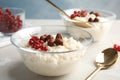 Creamy rice pudding with red currant and hazelnuts in bowl served Royalty Free Stock Photo