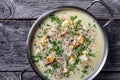 Creamy roasted garlic cauliflower soup in a pot