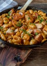 Creamy salmon with pasta shells in a cast iron pan