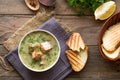 Creamy salmon soup with potatoes and carrots served with toast on a wooden rustic plank table. Finnish fish soup kalakeitto with s Royalty Free Stock Photo