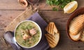 Creamy salmon soup with potatoes and carrots served with toast on a wooden rustic plank table. Finnish fish soup kalakeitto with s Royalty Free Stock Photo