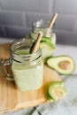 Creamy smoothie from avocado and banana in glass cups with paper tubes Royalty Free Stock Photo