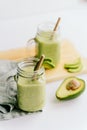 Creamy smoothie from avocado and banana in glass cups with paper tubes Royalty Free Stock Photo