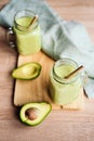 Creamy smoothie from avocado and banana in glass cups with paper tubes Royalty Free Stock Photo