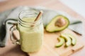 creamy smoothie from avocado and banana in glass cups with paper tubes Royalty Free Stock Photo