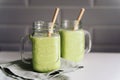 creamy smoothie from avocado and banana in glass cups with paper tubes Royalty Free Stock Photo