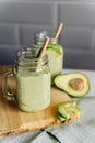 Creamy smoothie from avocado and banana in glass cups with paper tubes Royalty Free Stock Photo