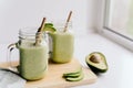 creamy smoothie from avocado and banana in glass cups with paper tubes Royalty Free Stock Photo