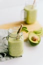 Creamy smoothie from avocado and banana in glass cups with paper tubes Royalty Free Stock Photo