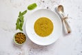 Creamy soup with green pea in a ceramic white plate Royalty Free Stock Photo