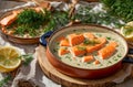 Creamy soup pieces salmon, lemon, dill eating an old background fresh fish healthy meal