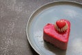 Creamy strawberry cookie in the shape of a heart with red glaze and a tiny red heart on whipped cream, dessert for Valentine`s Day Royalty Free Stock Photo