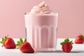 Creamy strawberry milkshake isolated on pink background