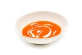 Creamy tomato soup in a white porcelain plate on a white background Royalty Free Stock Photo