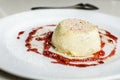Creamy vanilla panna cotta in raspberry sauce on the white plate