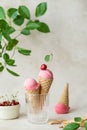 Creamy vegan cherries ice cream in the horn in a glass, styling cherry. Waffle cone horn upside down. Royalty Free Stock Photo