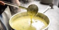 Creamy vegetable mixed soup steaming as ladle stirs it in a pot Royalty Free Stock Photo