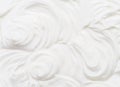 Creamy waves and swirls in yoghurt or cream surface. Top view Royalty Free Stock Photo