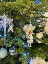 Creamy and white Christmas tree decorations: a girl and a rabbit. Close-up