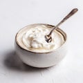 Creamy Yogurt Served in a White Bowl with Spoon on a Grey Background Highlighting Texture and Freshness Royalty Free Stock Photo