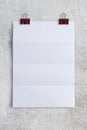 Crease Blank Paper and Clips on White Concrete table background