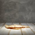 Creased brown paper with space for products. Grey wall background. Royalty Free Stock Photo