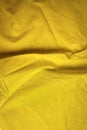 Creased fabric in easter yellow with copy space