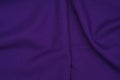 Creased purple gabardine. Rumpled texture. Folded fabric