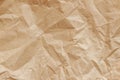 Creased, wrinkled crumpled brown cardboard. Recyclable material, texture, vintage background with copy space Royalty Free Stock Photo